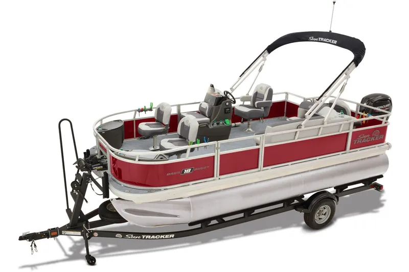 Slide: The Image of 2026 Sun Tracker Bass Buggy 18 DLX with Mercury outboard motor, parked outdoors. - 2