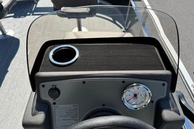 Slide: The Image of 2026 Sun Tracker Bass Buggy 16 XL Select dashboard with cup holder and gauge. - 13