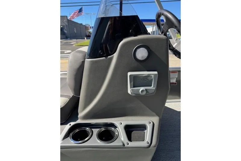 Slide: The Image of 2026 Sun Tracker Bass Buggy 16 XL Select console with cup holders and steering wheel. - 14