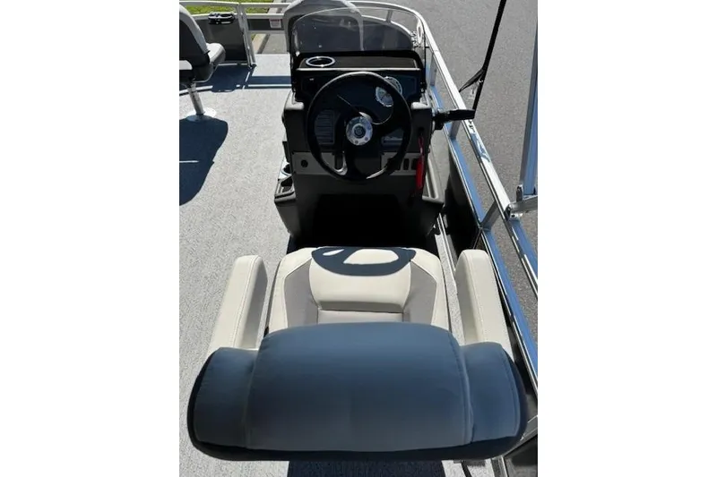 Slide: The Image of 2026 Sun Tracker Bass Buggy 16 XL Select boat interior with steering wheel and seating. - 15