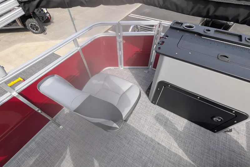 Slide: The Image of 2026 Sun Tracker SportFish 20 DLX boat interior with gray seating and control panel. - 6