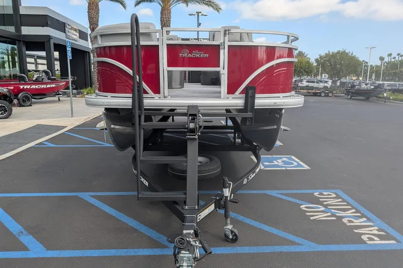 Slide: The Image of 2026 Sun Tracker SportFish 20 DLX pontoon boat on trailer in parking lot. - 4
