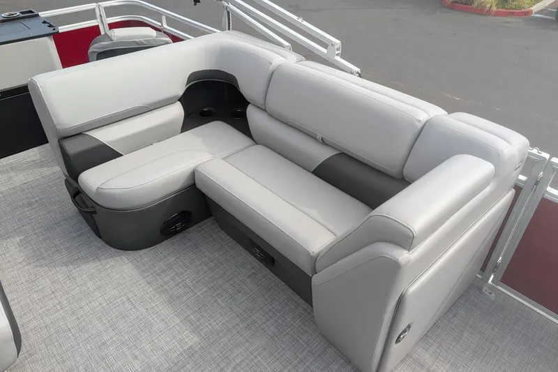 Slide: The Image of 2026 Sun Tracker SportFish 20 DLX pontoon boat seating, featuring plush gray upholstery. - 12