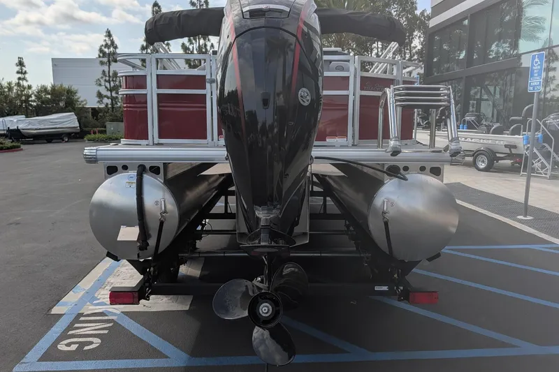 Slide: The Image of 2026 Sun Tracker SportFish 20 DLX pontoon boat rear view in parking lot. - 5