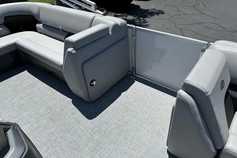 Slide: The Image of 2026 Sun Tracker Party Barge 20 DLX interior with gray seating and flooring. - 12