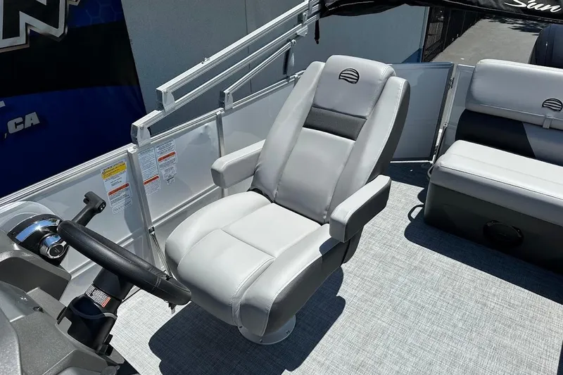 Slide: The Image of 2026 Sun Tracker Party Barge 20 DLX interior with captain's chair and steering wheel. - 15