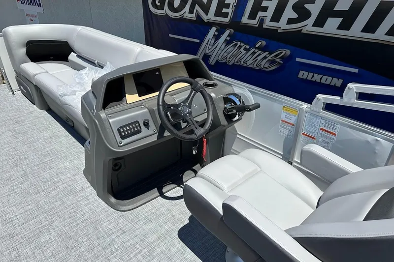 Slide: The Image of 2026 Sun Tracker Party Barge 20 DLX interior with steering console and seating. - 19