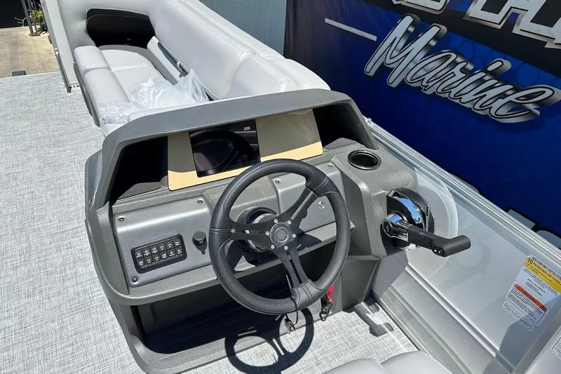 Slide: The Image of 2026 Sun Tracker Party Barge 20 DLX steering console with modern controls and seating. - 20