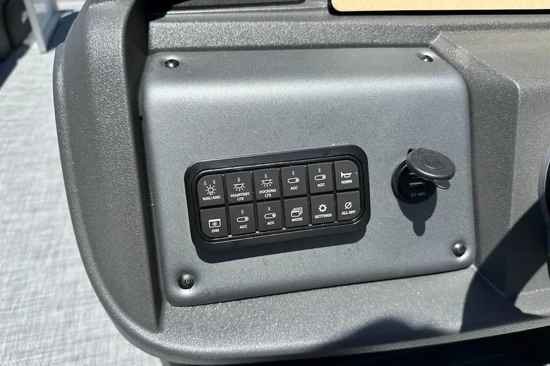 Slide: The Image of Control panel of 2026 Sun Tracker Party Barge 20 DLX with various switches and USB port. - 21