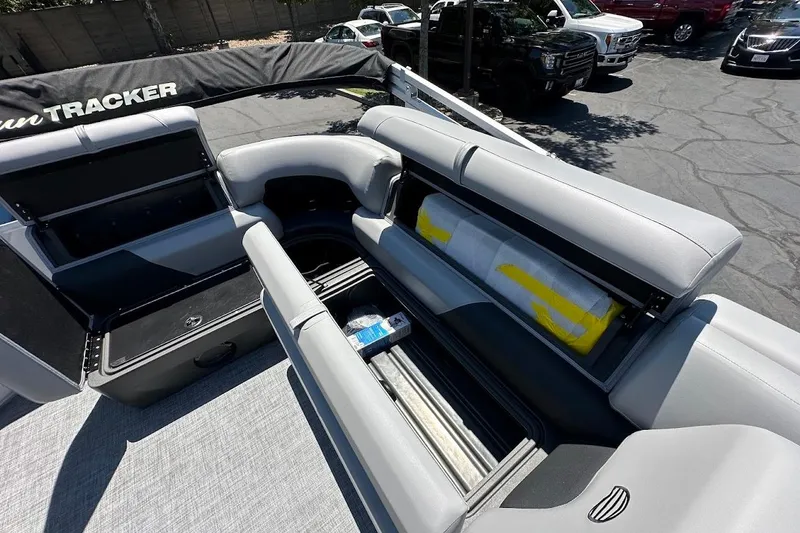 Slide: The Image of 2026 Sun Tracker Party Barge 20 DLX interior with open storage compartments. - 27