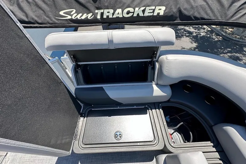 Slide: The Image of 2026 Sun Tracker Party Barge 20 DLX interior storage compartments and seating area. - 29