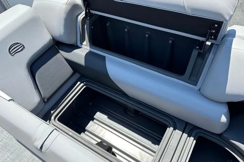 Slide: The Image of 2026 Sun Tracker Party Barge 20 DLX storage compartment with open lid, showcasing spacious interior. - 34