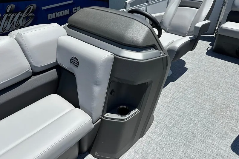 Slide: The Image of 2026 Sun Tracker Party Barge 20 DLX interior with gray seating and steering console. - 35