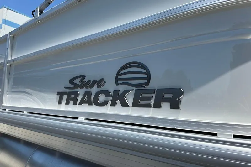 Slide: The Image of 2026 Sun Tracker Party Barge 20 DLX logo on boat exterior. - 7