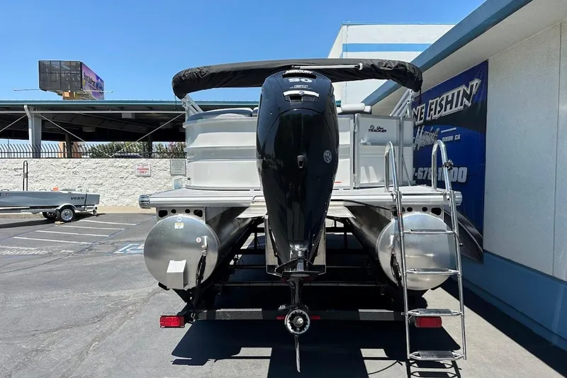 Slide: The Image of 2026 Sun Tracker Party Barge 20 DLX pontoon boat with outboard motor and ladder. - 9