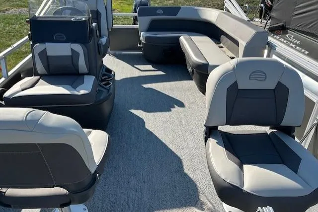 Slide: The Image of 2026 Sun Tracker Bass Buggy 16 XL Select pontoon boat interior with gray seating and carpet. - 4