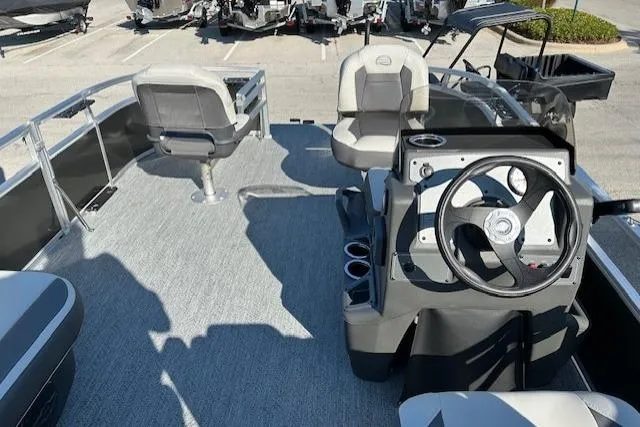 Slide: The Image of 2026 Sun Tracker Bass Buggy 16 XL Select pontoon boat interior with steering console and seating. - 5