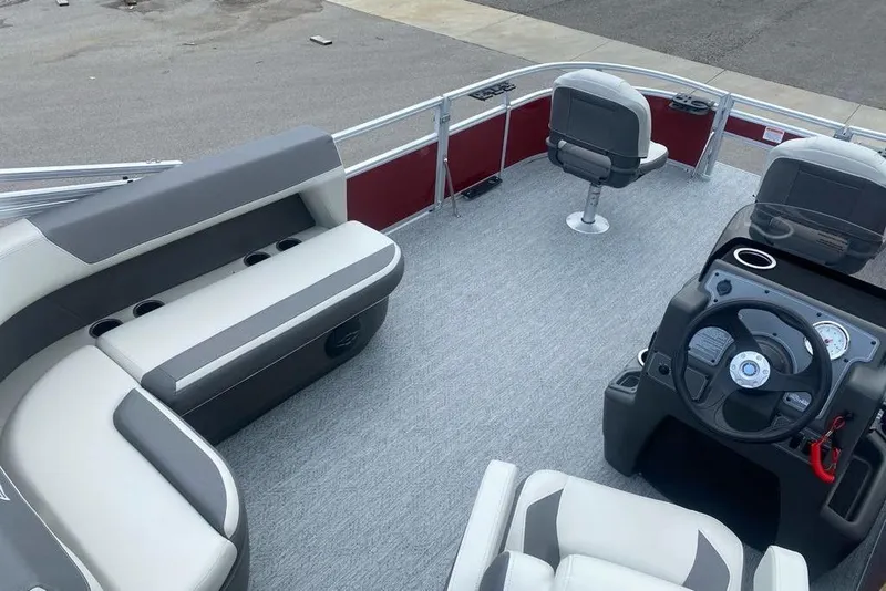 Slide: The Image of 2026 Sun Tracker Bass Buggy 16 XL Select pontoon boat interior with seating and steering console. - 6