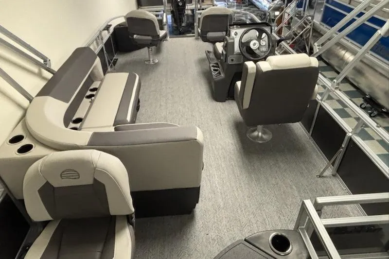 Slide: The Image of 2026 Sun Tracker Bass Buggy 18 DLX interior with seating and steering console. - 2