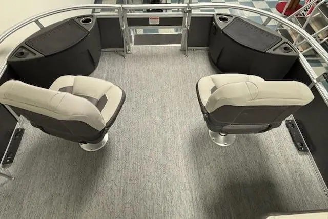 Slide: The Image of 2026 Sun Tracker Bass Buggy 18 DLX interior with two swivel seats and carpeted flooring. - 5