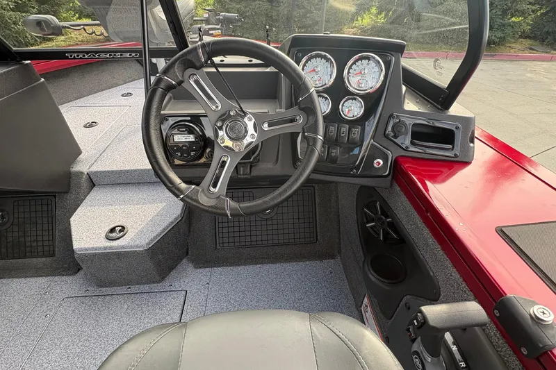 Slide: The Image of 2026 Tracker Targa V-19 Combo boat dashboard with steering wheel and gauges. - 60
