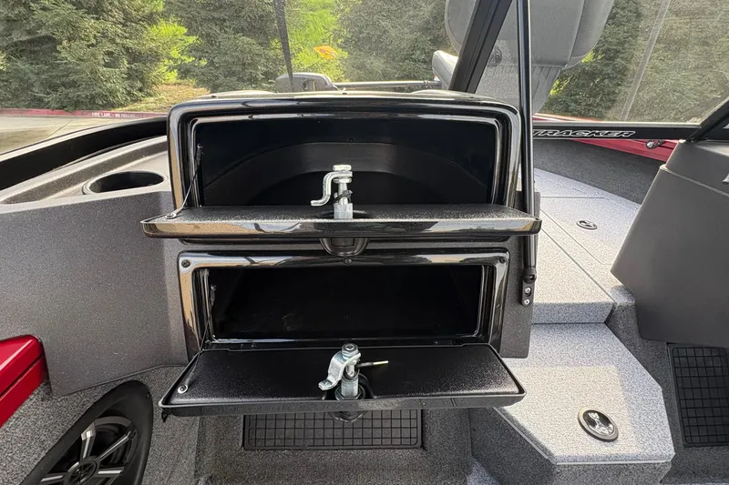 Slide: The Image of 2026 Tracker Targa V-19 Combo boat interior with open storage compartments. - 62