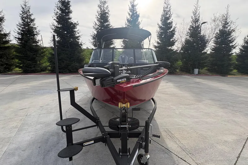 Slide: The Image of 2026 Tracker Targa V-19 Combo boat on trailer, parked outdoors. - 67