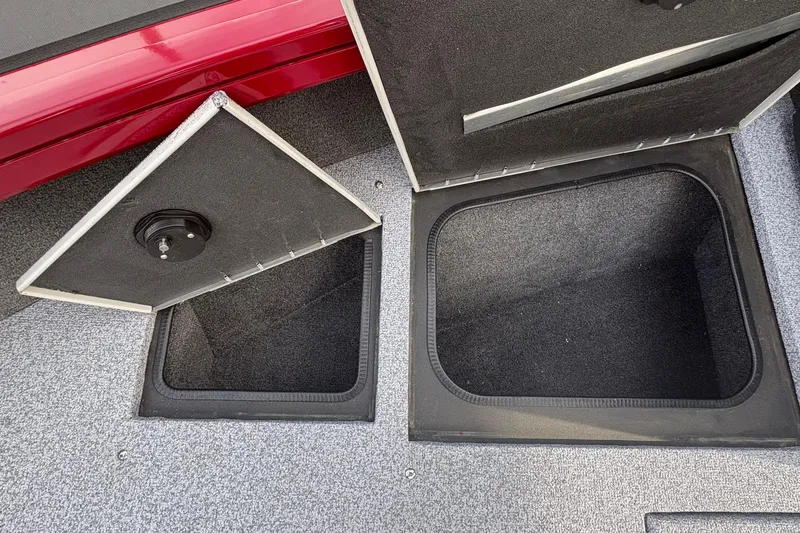 Slide: The Image of Open storage compartments on a 2026 Tracker Targa V-19 Combo boat. - 69