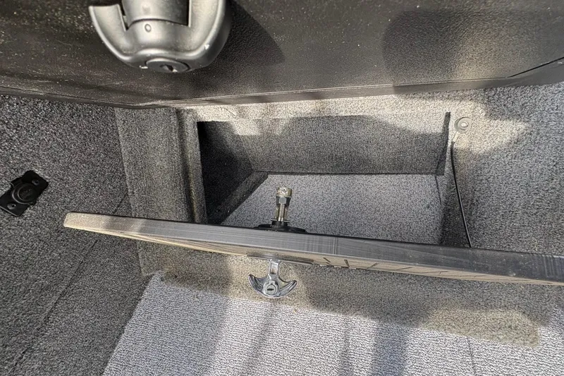 Slide: The Image of Storage compartment in 2026 Tracker Targa V-19 Combo boat, featuring carpeted interior. - 72