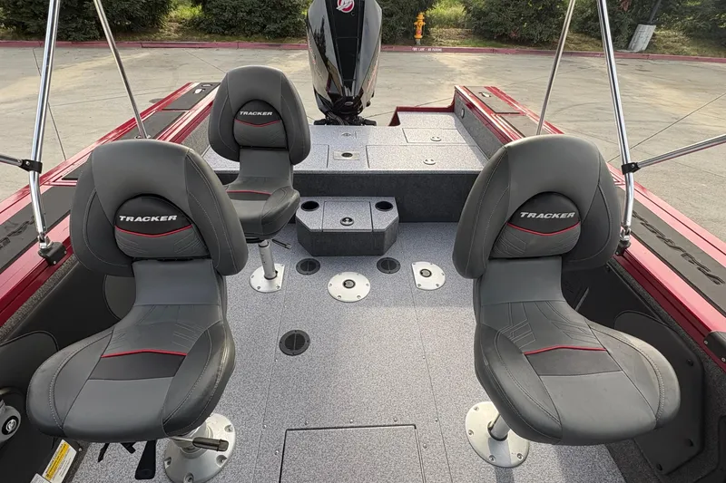 Slide: The Image of 2026 Tracker Targa V-19 Combo boat interior with gray seats and red accents. - 74