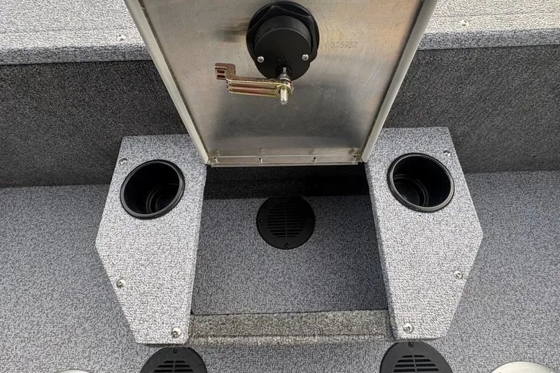 Slide: The Image of 2026 Tracker Targa V-19 Combo boat interior with cup holders and storage compartment. - 76