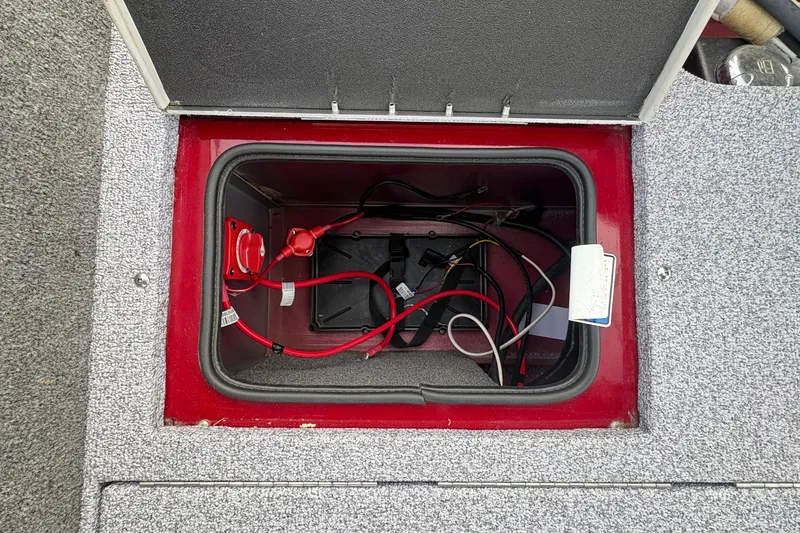 Slide: The Image of Open compartment of 2026 Tracker Targa V-19 Combo boat showing wiring and battery connections. - 80