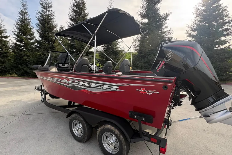 Slide: The Image of 2026 Tracker Targa V-19 Combo boat with canopy and powerful outboard motor. - 83