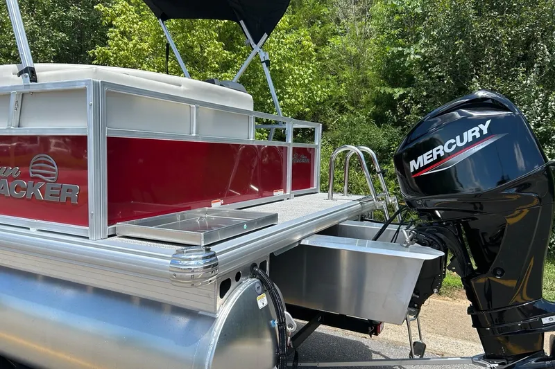 Slide: The Image of 2026 Sun Tracker Bass Buggy 16 XL Select pontoon boat with Mercury outboard motor. - 2