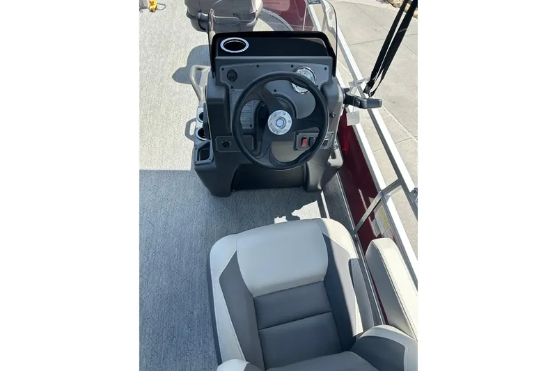 Slide: The Image of 2026 Sun Tracker Bass Buggy 16 XL Select boat interior with steering console and seating. - 3