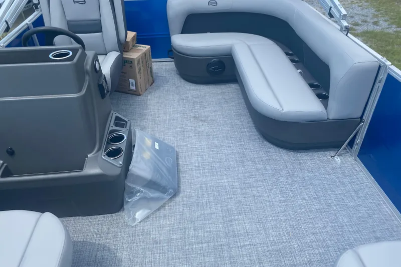 Slide: The Image of 2026 Sun Tracker Party Barge 16 DLX interior with gray seating and console. - 2
