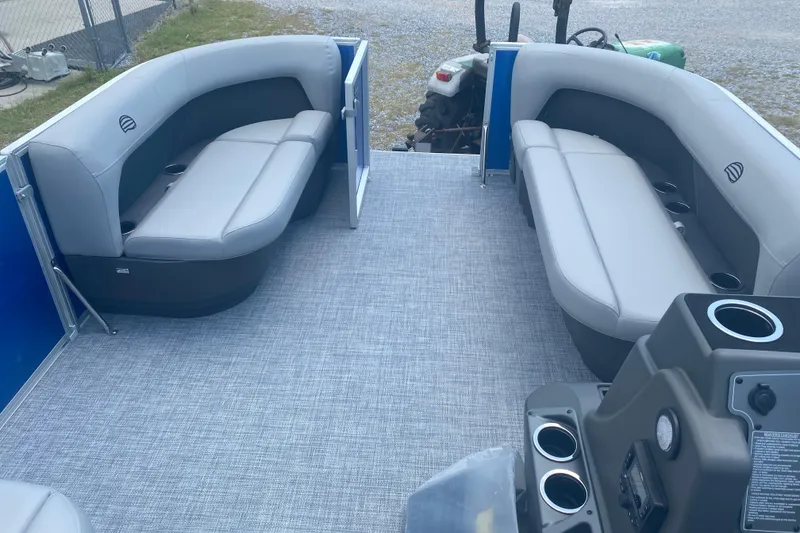 Slide: The Image of 2026 Sun Tracker Party Barge 16 DLX interior with gray seating and cup holders. - 3