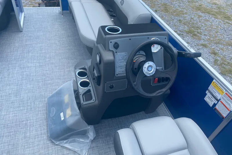 Slide: The Image of 2026 Sun Tracker Party Barge 16 DLX interior with steering console and seating. - 4