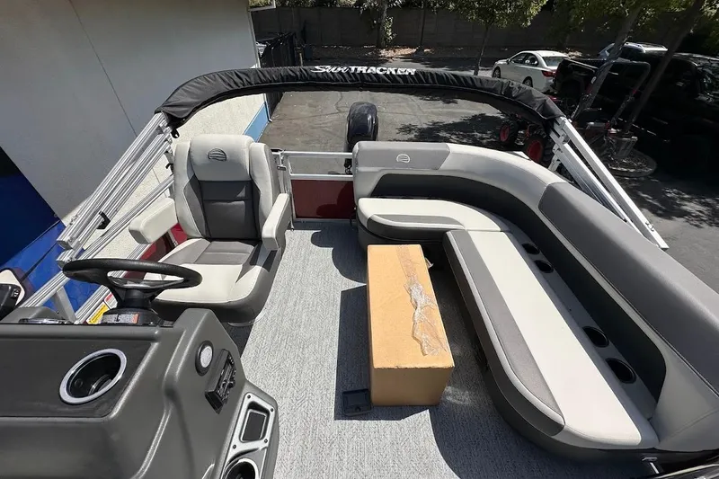 Slide: The Image of 2026 Sun Tracker Bass Buggy 16 XL Select interior with seating and steering console. - 11