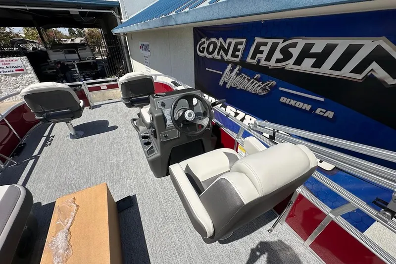 Slide: The Image of 2026 Sun Tracker Bass Buggy 16 XL Select pontoon boat interior with seating and steering console. - 14