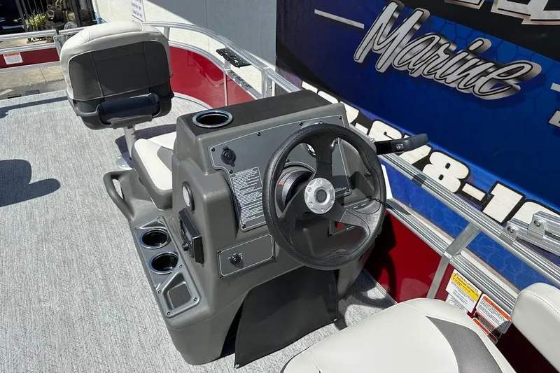 Slide: The Image of 2026 Sun Tracker Bass Buggy 16 XL Select boat interior with steering console and seating. - 15