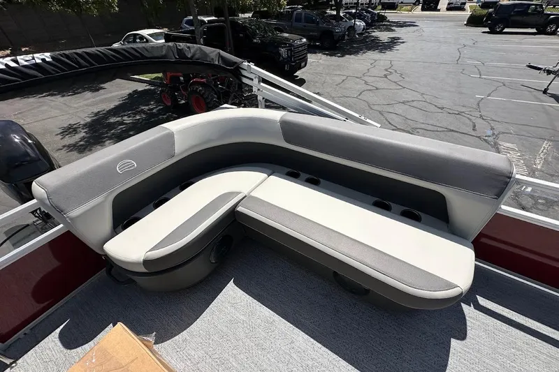 Slide: The Image of 2026 Sun Tracker Bass Buggy 16 XL Select boat seating, gray and white upholstery, outdoor setting. - 26