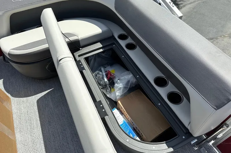 Slide: The Image of 2026 Sun Tracker Bass Buggy 16 XL Select boat seat storage with cup holders and gear. - 27