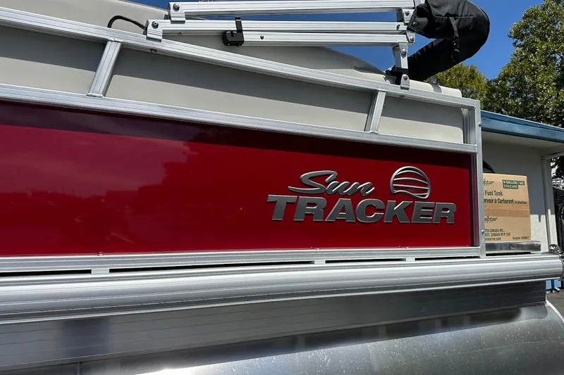Slide: The Image of 2026 Sun Tracker Bass Buggy 16 XL Select pontoon boat with red and silver detailing. - 5