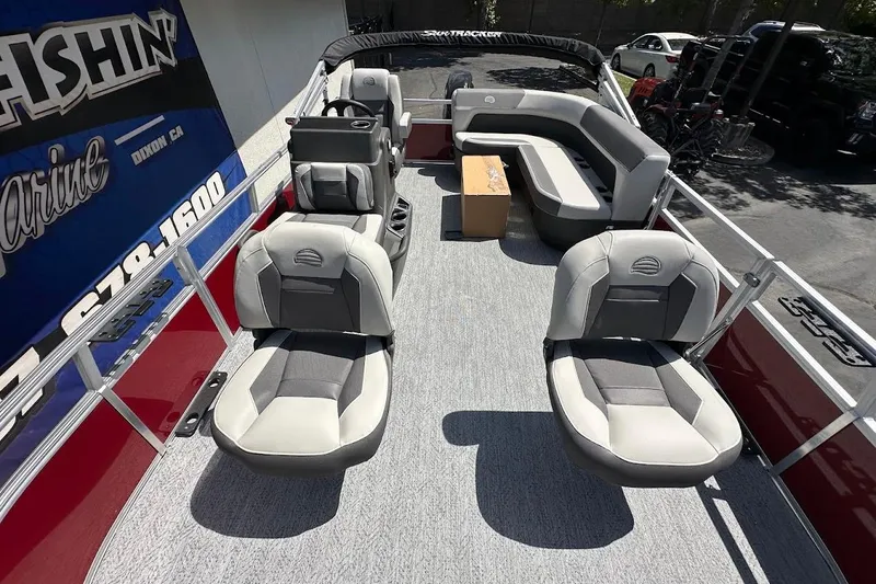 Slide: The Image of 2026 Sun Tracker Bass Buggy 16 XL Select pontoon boat interior with seating and helm. - 9