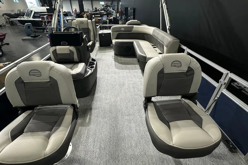Slide: The Image of 2026 Sun Tracker Bass Buggy 18 DLX pontoon boat interior with plush seating and modern design. - 22