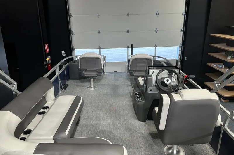 Slide: The Image of 2026 Sun Tracker Bass Buggy 18 DLX interior with seating and steering console. - 23