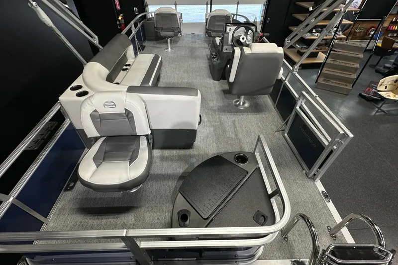 Slide: The Image of 2026 Sun Tracker Bass Buggy 18 DLX pontoon boat interior with seating and steering console. - 24