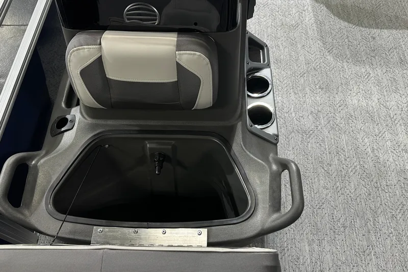 Slide: The Image of Interior of 2026 Sun Tracker Bass Buggy 18 DLX with storage compartment and cup holders. - 26