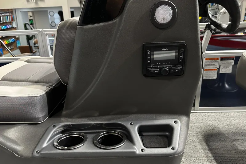 Slide: The Image of 2026 Sun Tracker Bass Buggy 18 DLX console with stereo system and cup holders. - 32